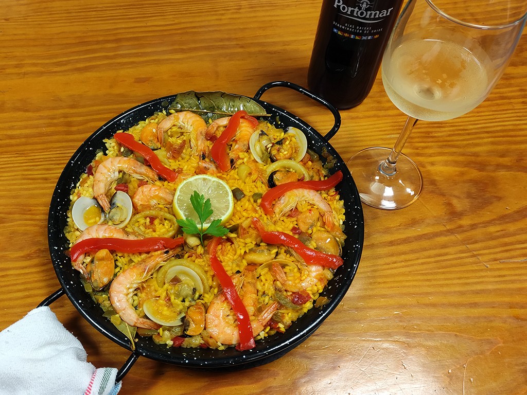 Paella decorated with strips of red pepper